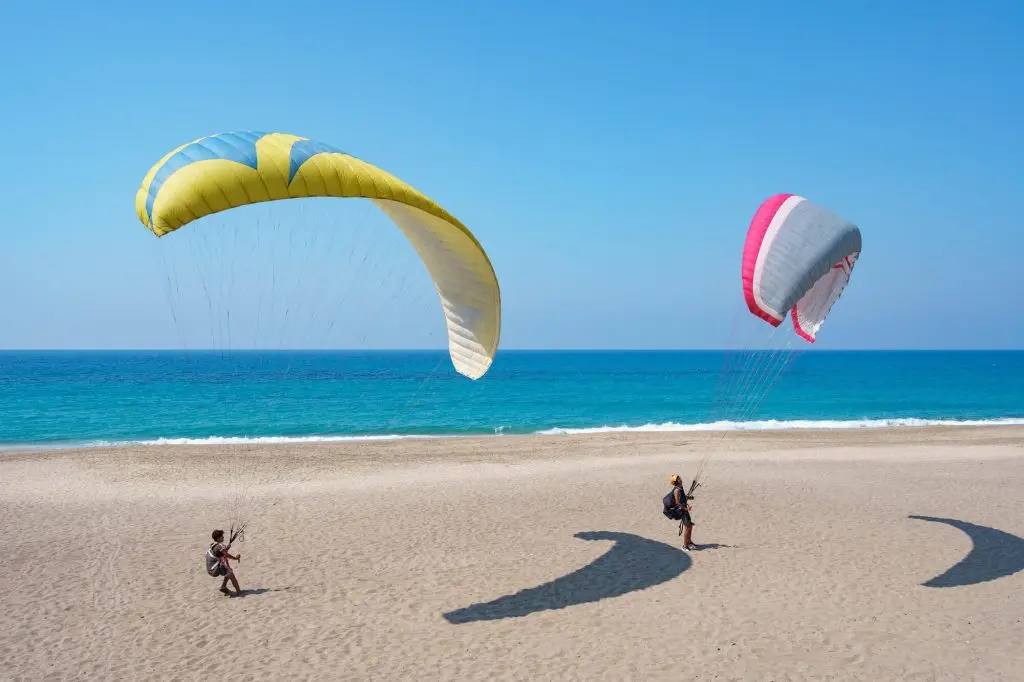 Parachute riding is fun activities to do at the beach